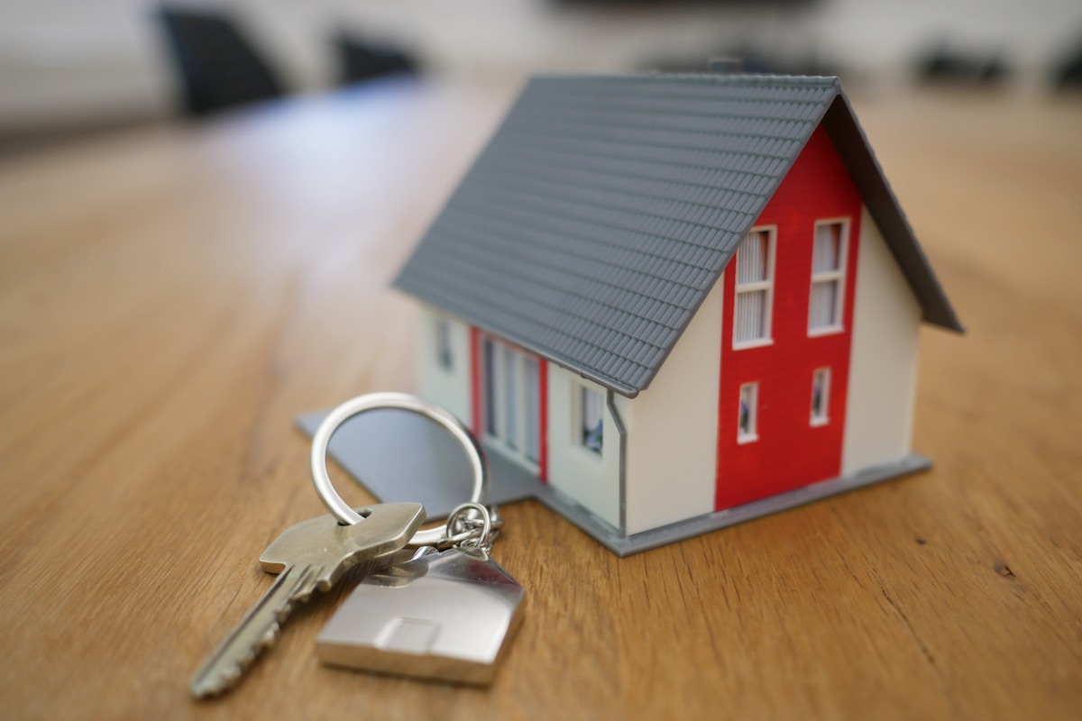 Host holding keys to a cozy guest room